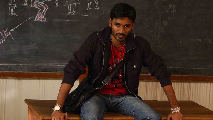 Dhanush Sitting Pose On Table In Classroom In Kutty Movie